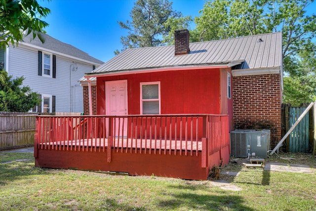 1847 Warren St, Augusta, GA 30904 - back of house with a chimney, central AC, a wooden deck, and fence