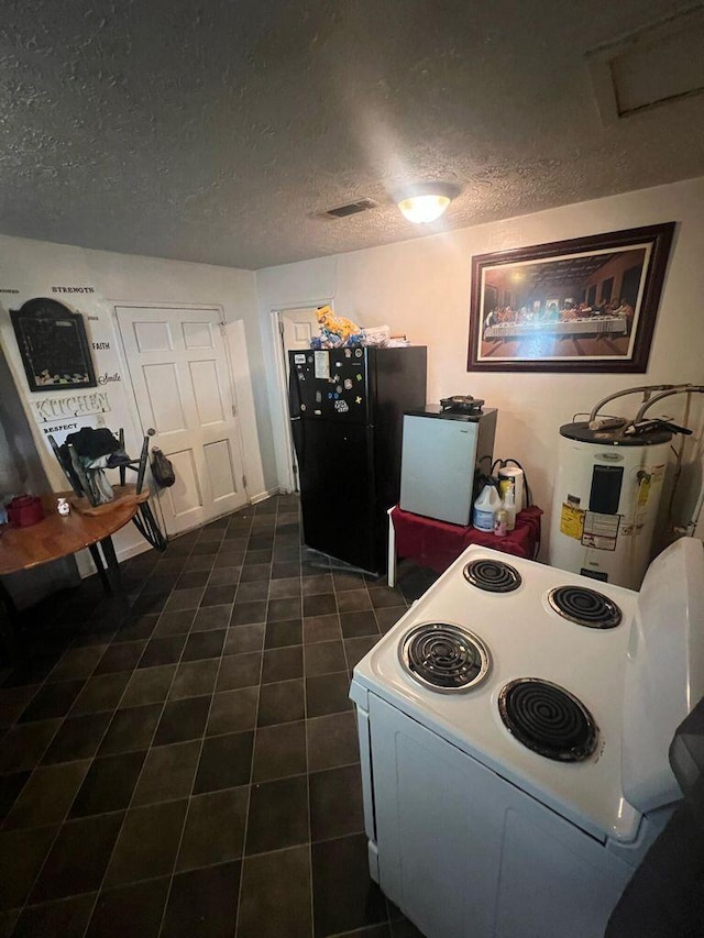 dining area featuring visible vents, a textured ceiling, and electric water heater