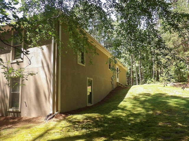 view of side of property with a lawn