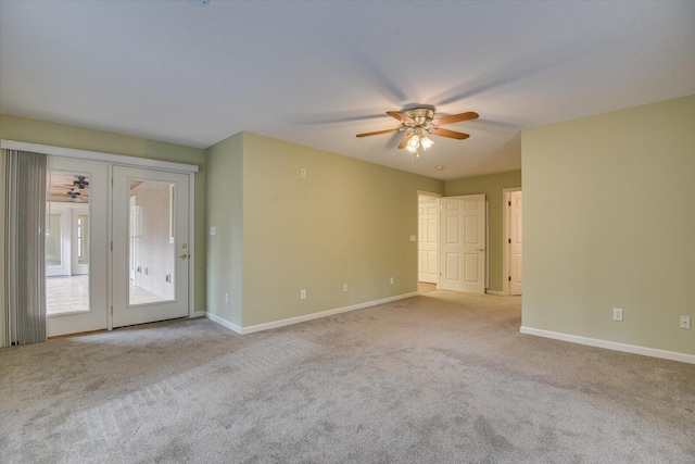 carpeted spare room with ceiling fan