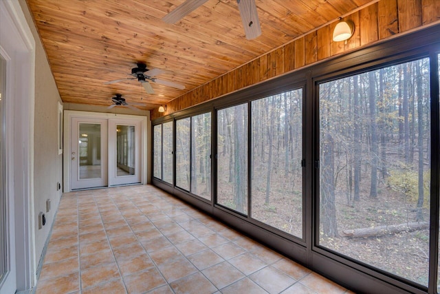 unfurnished sunroom with ceiling fan and wooden ceiling