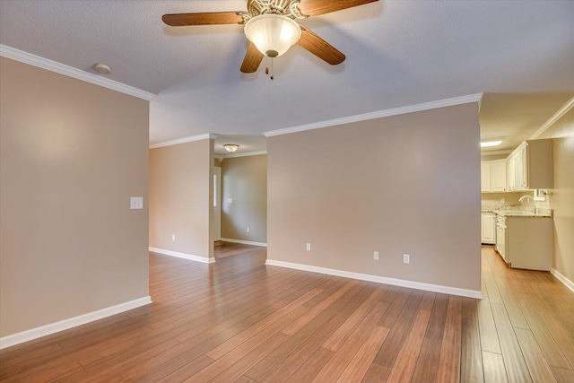 unfurnished room with ceiling fan, ornamental molding, and light hardwood / wood-style flooring