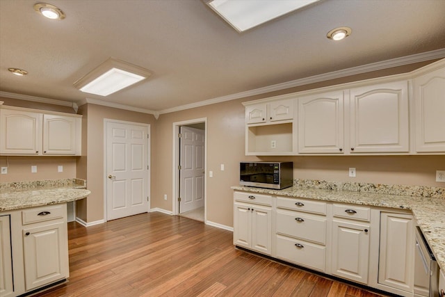 kitchen featuring light wood-type flooring, light stone counters, and ornamental molding