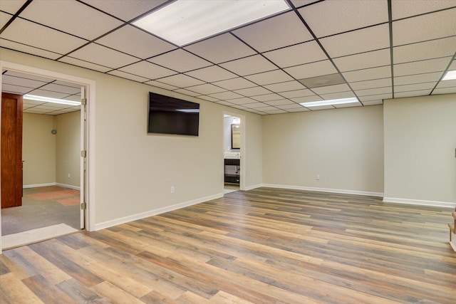 basement featuring hardwood / wood-style floors and a drop ceiling