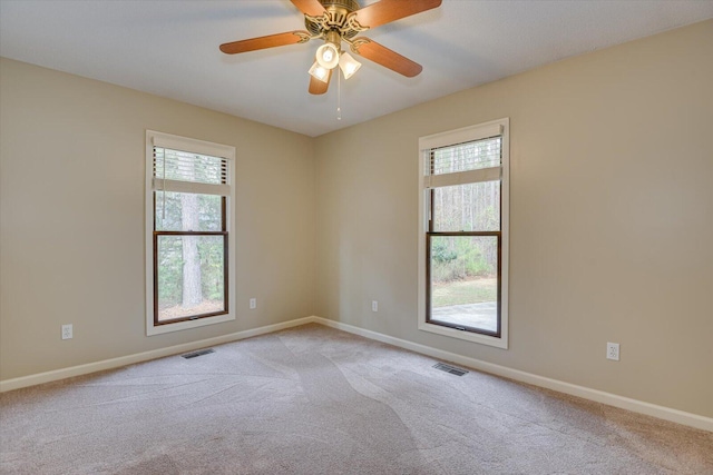 unfurnished room featuring ceiling fan and light carpet