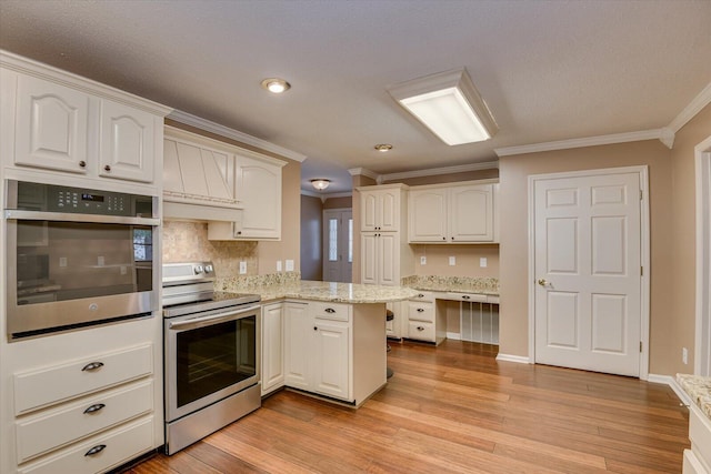 kitchen featuring kitchen peninsula, light wood-type flooring, light stone counters, ornamental molding, and stainless steel appliances