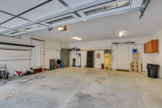 garage with a garage door opener and gas water heater