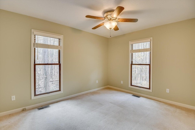 empty room with light carpet and ceiling fan