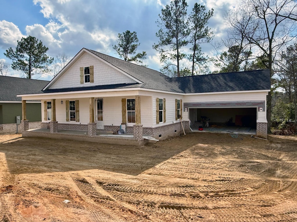 view of front of home featuring a garage and covered porch