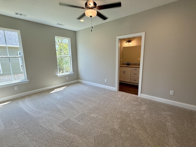213 Whiskey Rd, Grovetown, GA 30813 - unfurnished bedroom with baseboards, visible vents, dark colored carpet, and a sink