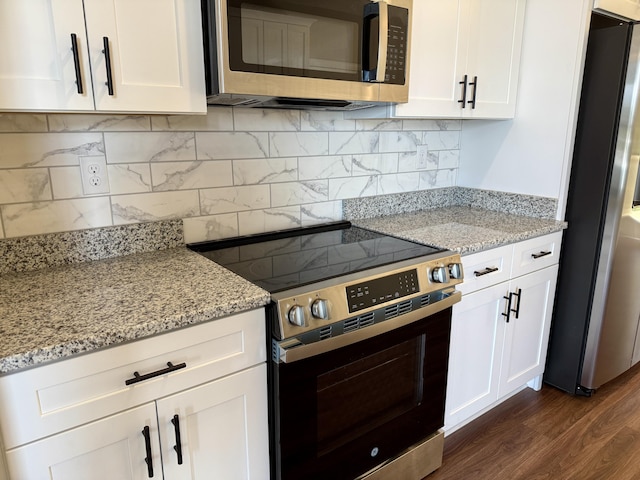 213 Whiskey Rd, Grovetown, GA 30813 - kitchen with dark wood-style floors, white cabinetry, decorative backsplash, and appliances with stainless steel finishes