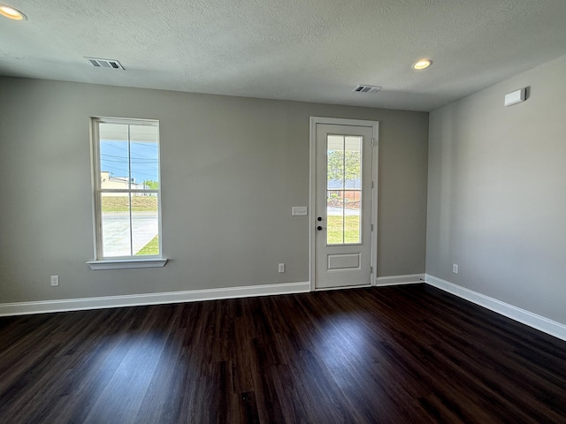 213 Whiskey Rd, Grovetown, GA 30813 - interior space with baseboards, dark wood-style flooring, a textured ceiling, and a healthy amount of sunlight