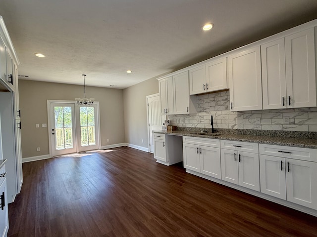 213 Whiskey Rd, Grovetown, GA 30813 - kitchen featuring a notable chandelier, a sink, tasteful backsplash, white cabinets, and dark wood-style flooring