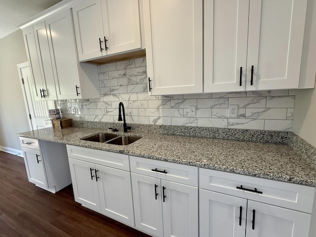 213 Whiskey Rd, Grovetown, GA 30813 - kitchen with white cabinetry, dark wood-type flooring, decorative backsplash, a sink, and light stone countertops