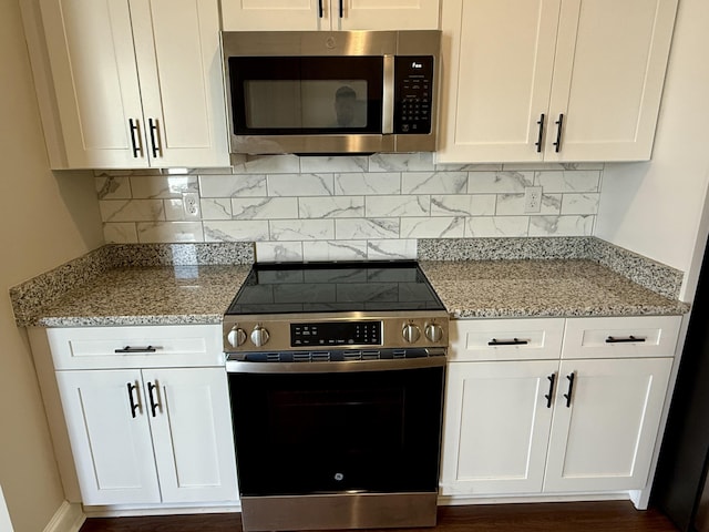 213 Whiskey Rd, Grovetown, GA 30813 - kitchen with backsplash, white cabinets, appliances with stainless steel finishes, and light stone counters