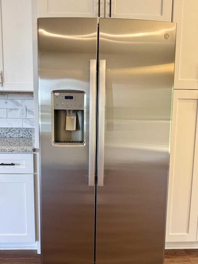 213 Whiskey Rd, Grovetown, GA 30813 - details featuring white cabinets, light stone countertops, wood finished floors, tasteful backsplash, and stainless steel refrigerator with ice dispenser