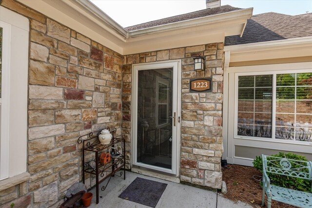 1223 Brookstone Way, Augusta, GA 30909 - property entrance with stone siding, a chimney, and a shingled roof