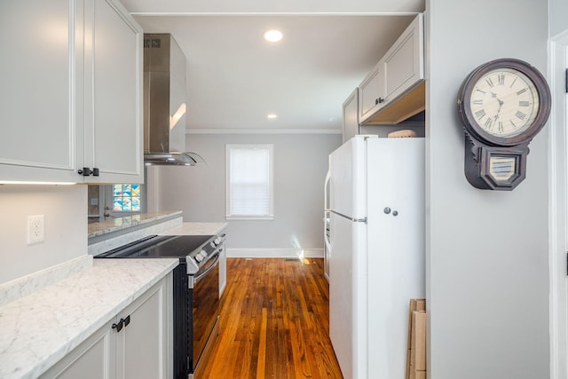 2217 Montclair St, Augusta, GA 30904 - kitchen featuring freestanding refrigerator, stainless steel range with electric stovetop, wall chimney exhaust hood, recessed lighting, and plenty of natural light