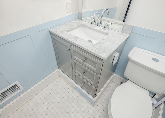 2217 Montclair St, Augusta, GA 30904 - half bath featuring vanity, a wainscoted wall, and a decorative wall