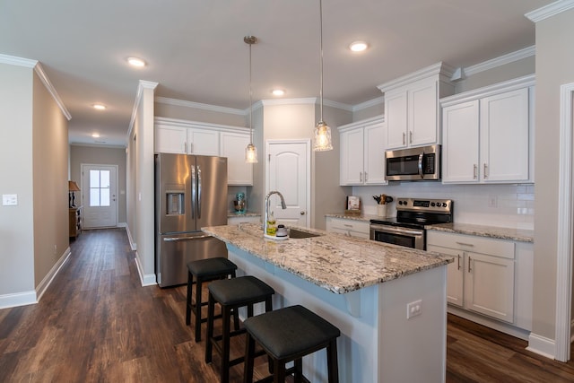 kitchen featuring appliances with stainless steel finishes, crown molding, a sink, and dark wood-style floors