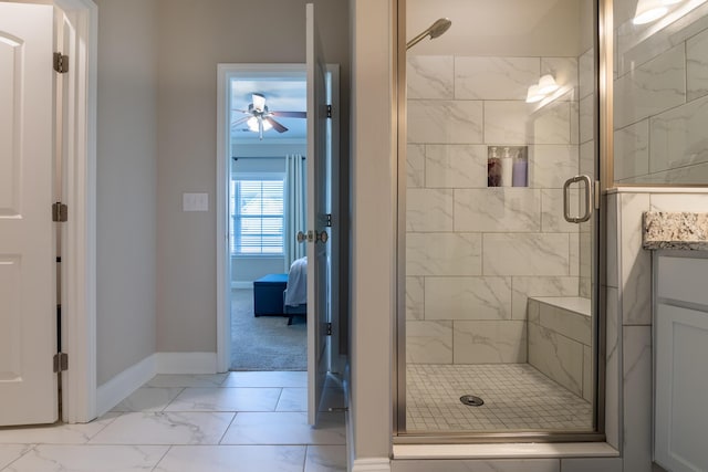 bathroom featuring marble finish floor, a ceiling fan, a stall shower, vanity, and baseboards