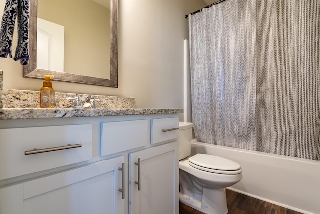 bathroom featuring shower / bath combination with curtain, wood finished floors, vanity, and toilet