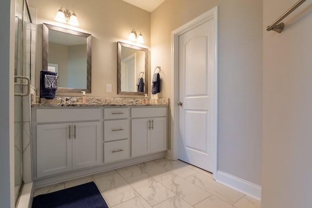 full bathroom featuring a sink, baseboards, marble finish floor, double vanity, and an enclosed shower