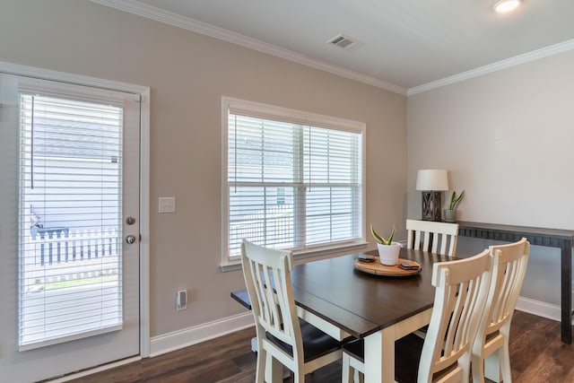 dining room featuring ornamental molding, dark wood-type flooring, visible vents, and baseboards