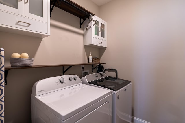 laundry area with cabinet space and separate washer and dryer