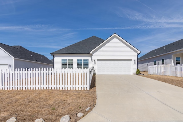 ranch-style home featuring a garage, concrete driveway, a shingled roof, and fence