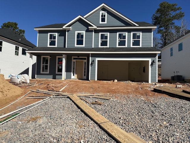 view of front of property with cooling unit, a garage, and a porch