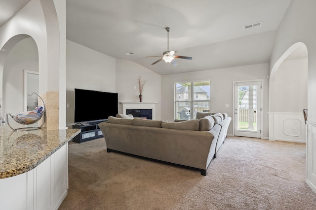 5315 Bull St, Augusta, GA 30909 - living room with light carpet, lofted ceiling, ceiling fan, a fireplace, and arched walkways