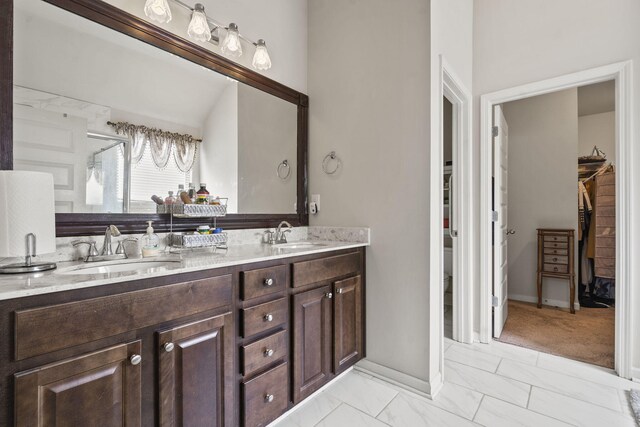 5315 Bull St, Augusta, GA 30909 - full bath featuring a spacious closet, double vanity, marble look tile flooring, and a shower with door