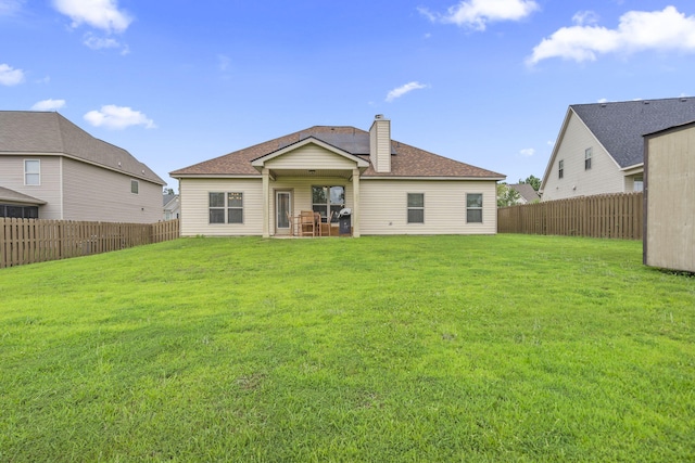 5315 Bull St, Augusta, GA 30909 - back of property with a chimney, a fenced backyard, and roof with shingles