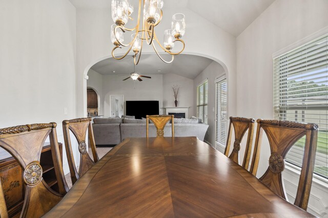 5315 Bull St, Augusta, GA 30909 - dining space featuring vaulted ceiling, arched walkways, a ceiling fan, a chandelier, and a fireplace