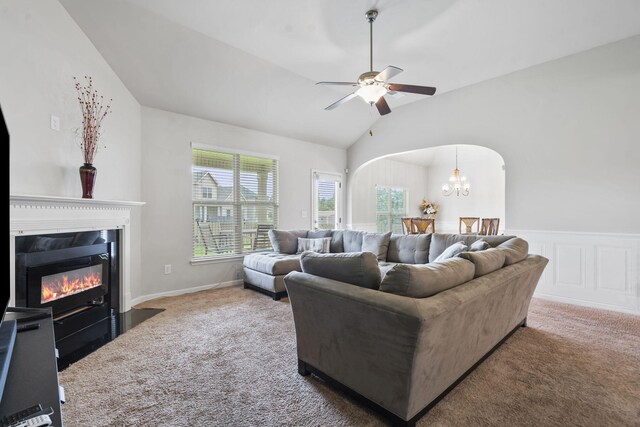 5315 Bull St, Augusta, GA 30909 - living room with carpet floors, ceiling fan, lofted ceiling, a fireplace with flush hearth, and a chandelier