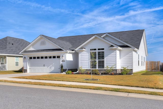 ranch-style home with a front lawn and a garage