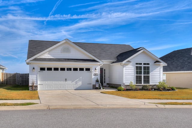 ranch-style house with a garage and a front lawn