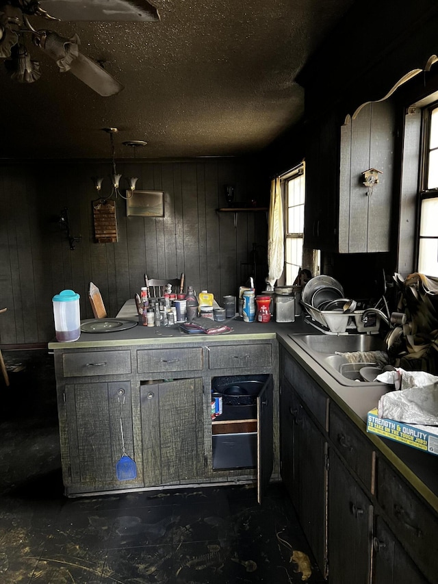 kitchen with a textured ceiling and a sink