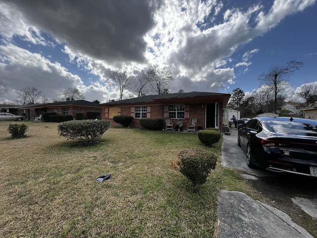 view of front of property with a front lawn, a porch, and brick siding