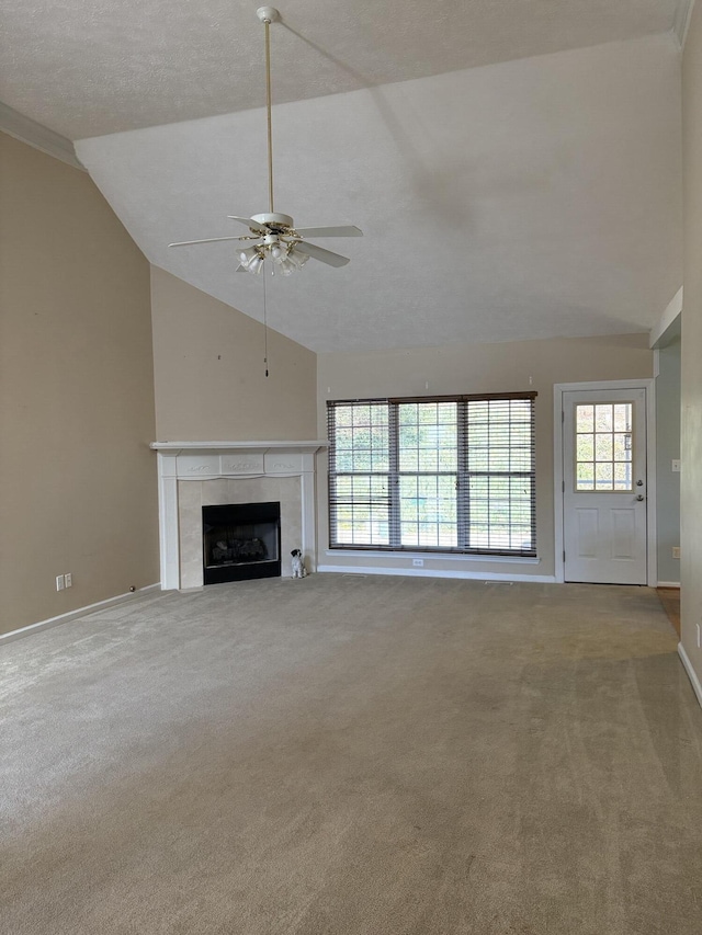 unfurnished living room with a tiled fireplace, carpet flooring, and a healthy amount of sunlight