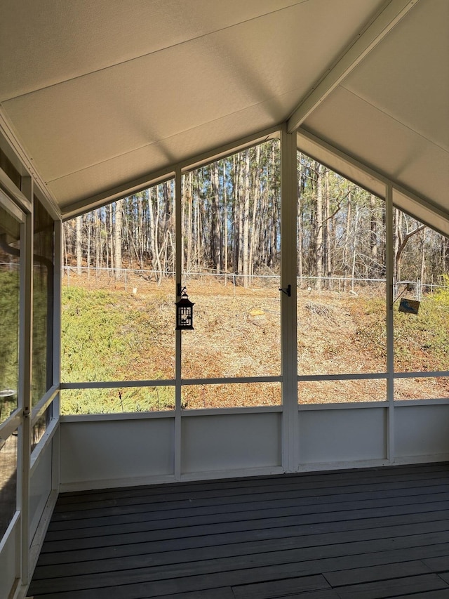 unfurnished sunroom featuring lofted ceiling