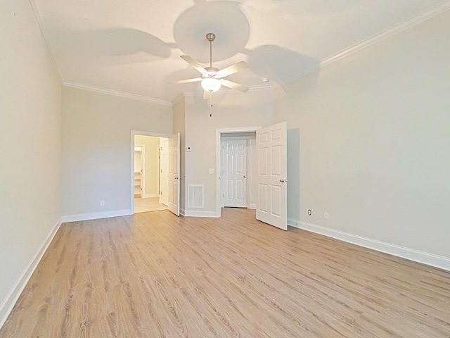 unfurnished bedroom featuring light wood-style floors, baseboards, ornamental molding, and visible vents