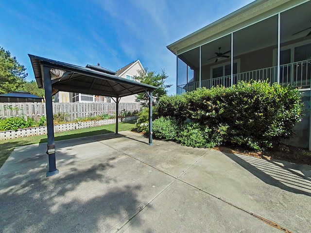 view of patio / terrace featuring a gazebo, fence, and ceiling fan