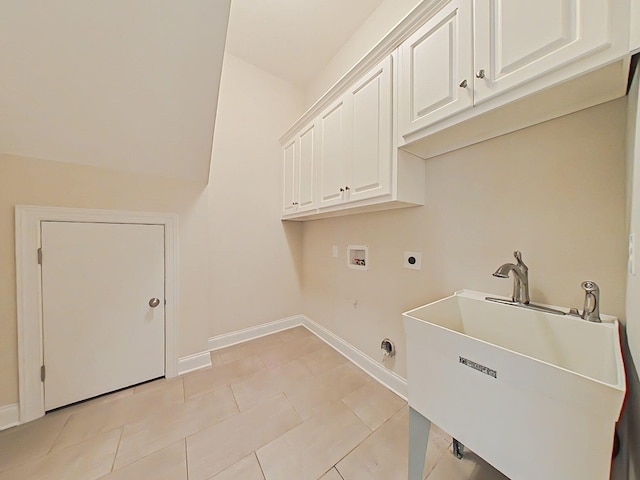washroom with electric dryer hookup, cabinet space, a sink, baseboards, and hookup for a washing machine