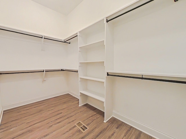 walk in closet featuring wood finished floors and visible vents