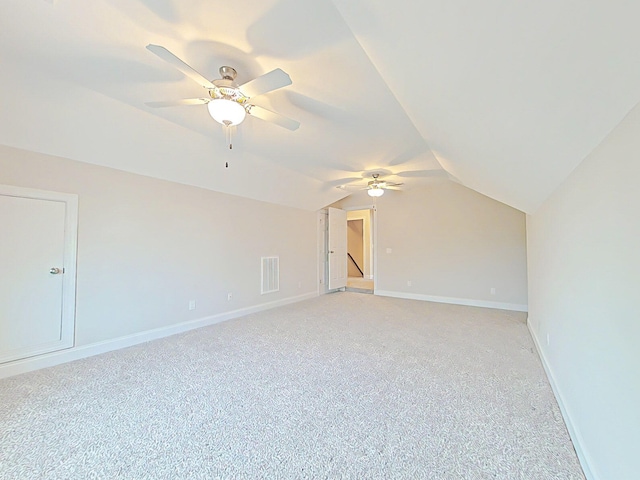 bonus room with a ceiling fan, light colored carpet, and lofted ceiling