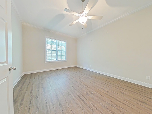 empty room with baseboards, ornamental molding, a ceiling fan, and wood finished floors