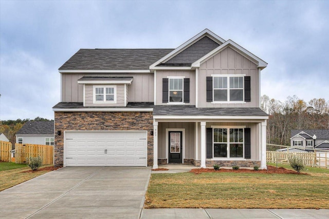 839 Sweetgrass Cir, Harlem, GA 30814 - craftsman-style house with stone siding, an attached garage, fence, and board and batten siding