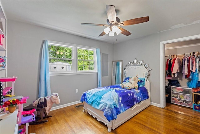 bedroom with wood finished floors, baseboards, a closet, and ceiling fan